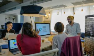A diverse team collaborates in a modern office meeting, emphasizing teamwork and innovation.