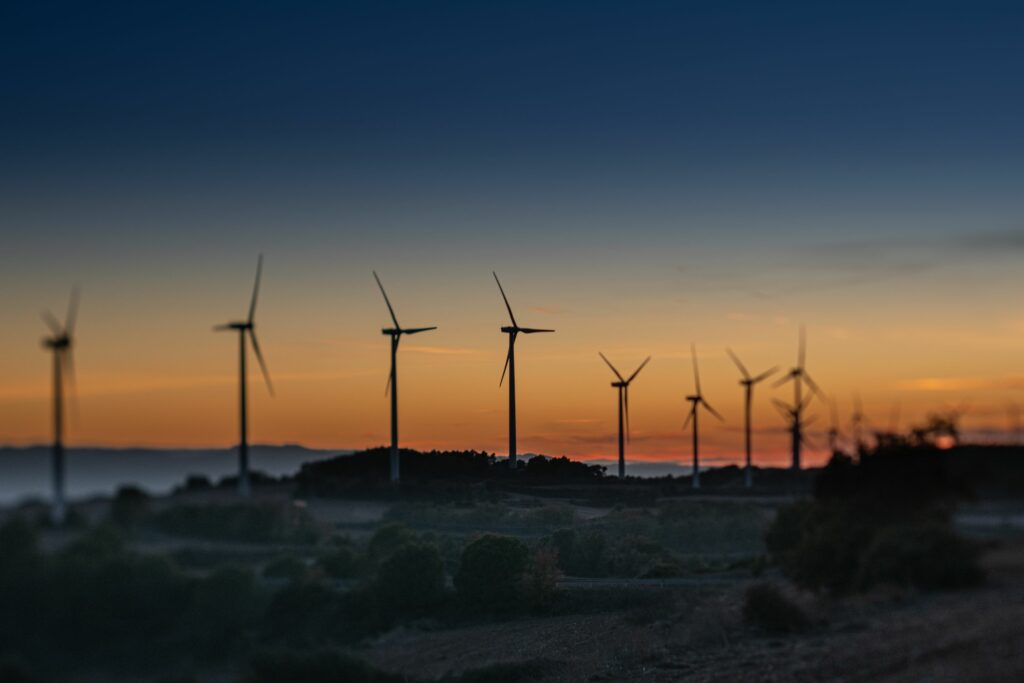 Scenic view of a wind farm in Lleida, Spain during a vibrant sunset.
