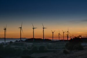Scenic view of a wind farm in Lleida, Spain during a vibrant sunset.